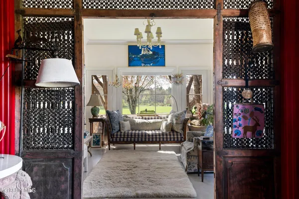 a living room with furniture a rug and a table