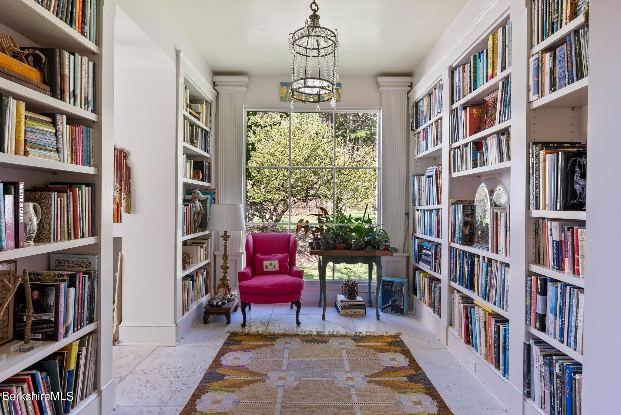 77 Seekonk Cross Road Great Barrington, MA 01230 - Photo 22 of 66 a living room with furniture lots of books and a book shelf