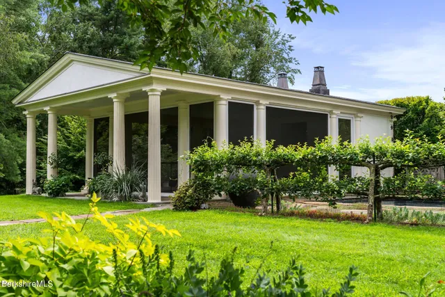 a view of a house with a yard and plants