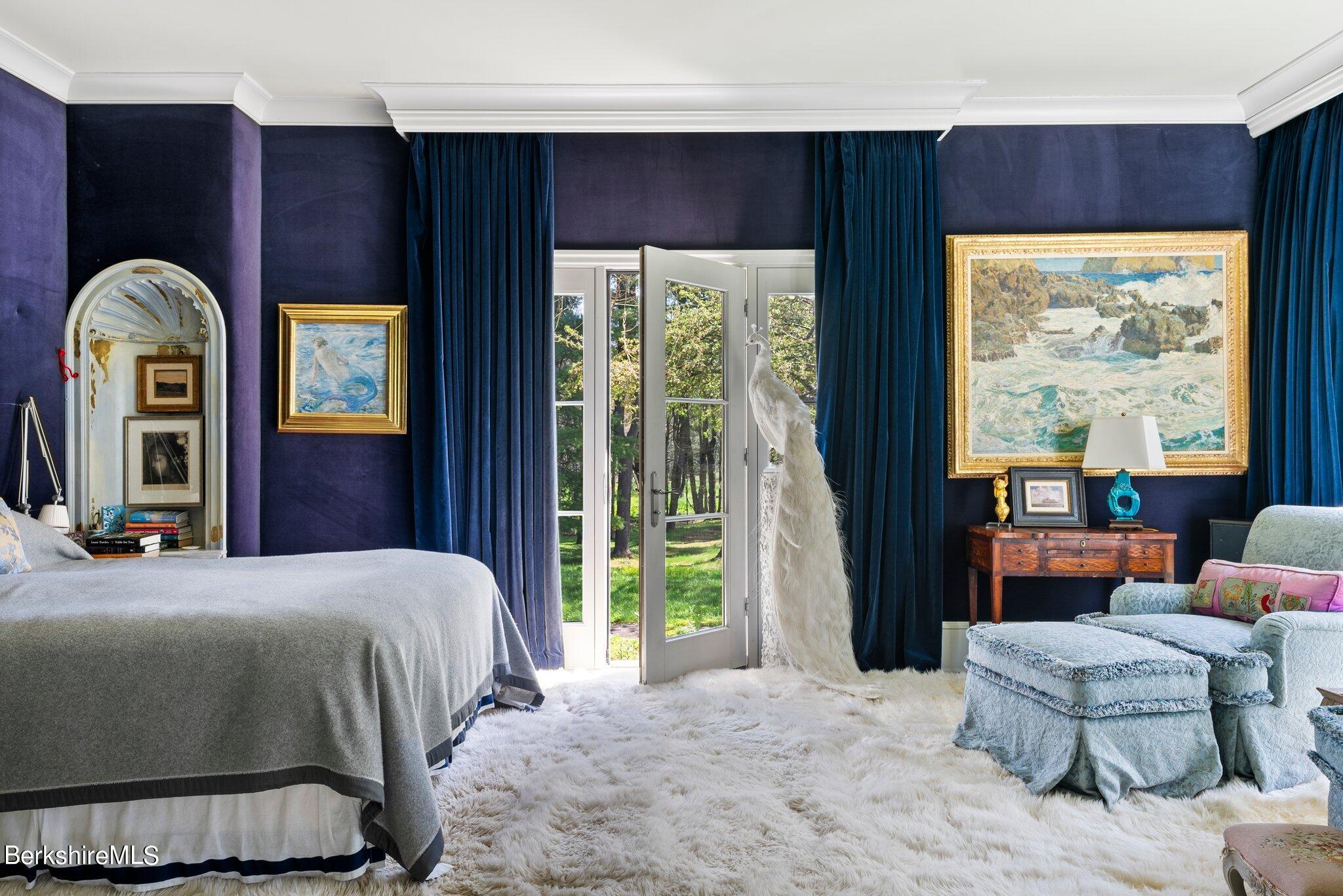 77 Seekonk Cross Road Great Barrington, MA 01230 - Photo 32 of 66 a bedroom with a balcony a bed and a painting on the wall