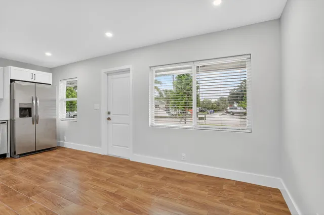 a kitchen with white cabinets and stainless steel appliances