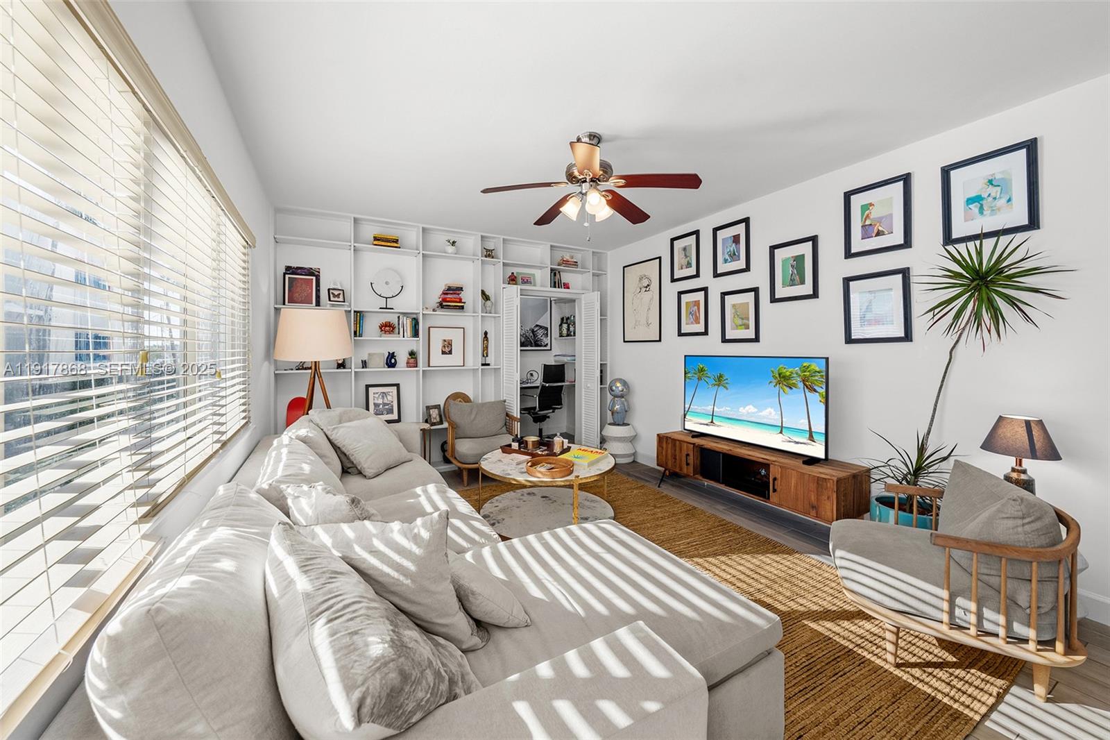 1120 Venetian Way, Unit 1D Miami, FL 33139 - Photo 2 of 11 a living room with furniture and a flat screen tv