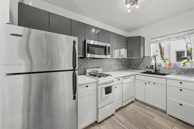 a white refrigerator freezer sitting inside of a kitchen