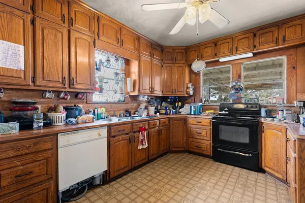 a view of a kitchen with fridge and workspace