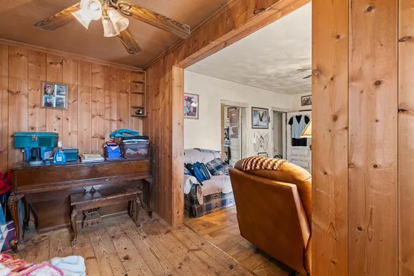 a living room with furniture ceiling fan and a window