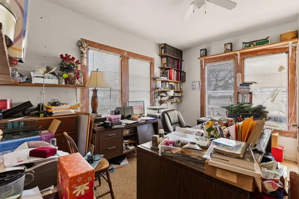 a bathroom with a window and a chair
