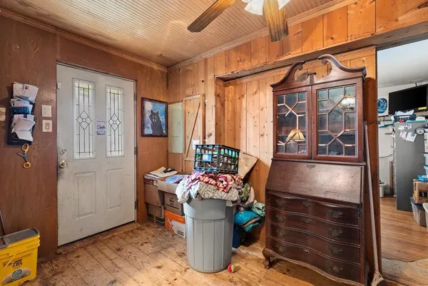 a kitchen view of a fireplace and a window