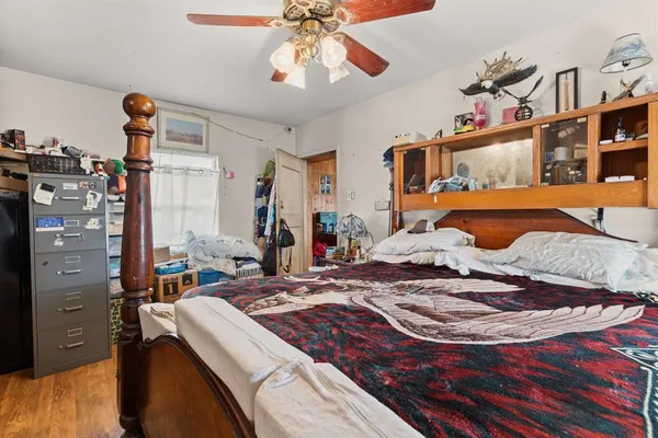 a bedroom with a bed and a chandelier