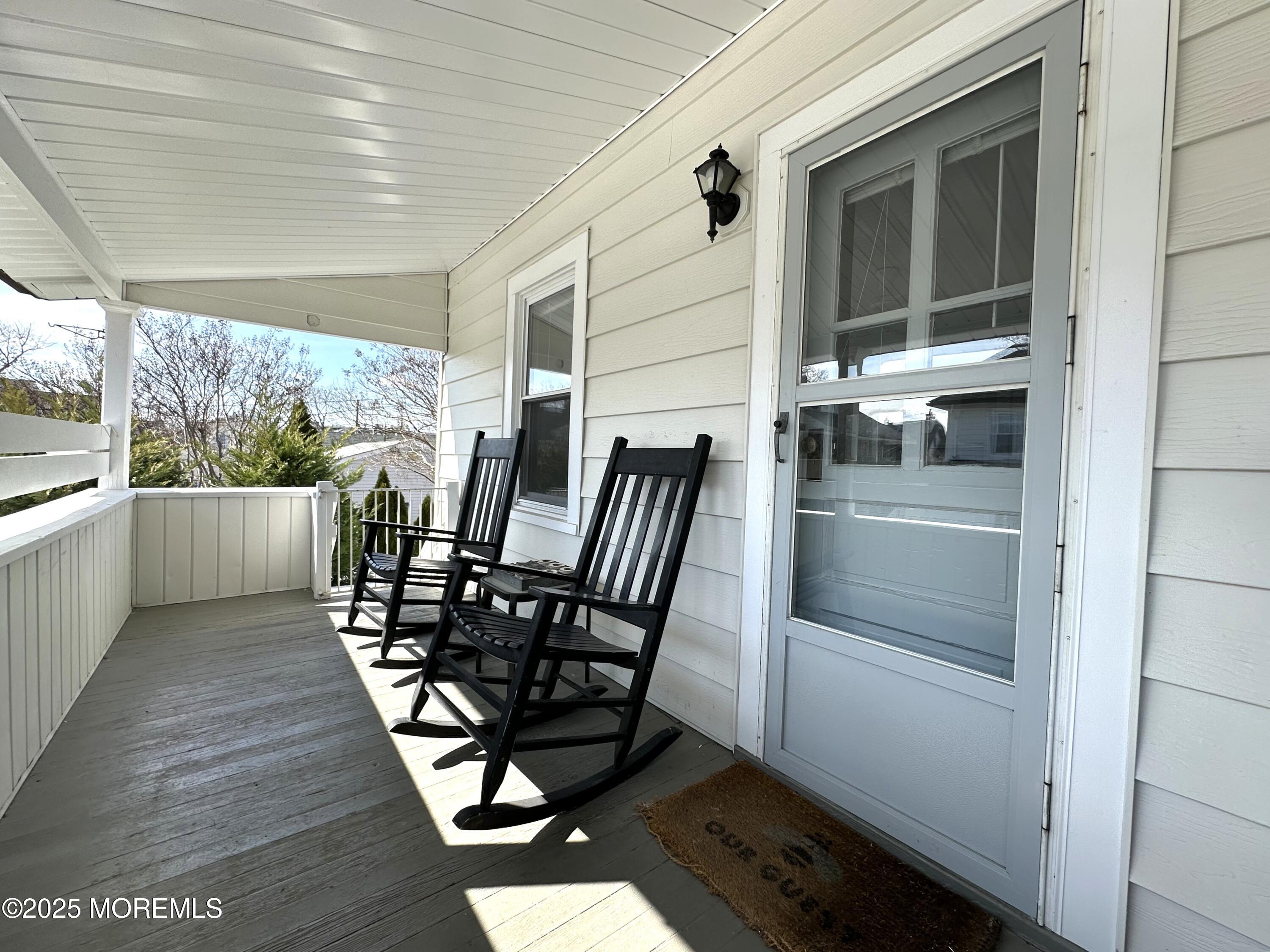 506 7th Avenue, Unit REAR Belmar, NJ 07719 - Photo 1 of 16 a view of a chairs and table in a balcony