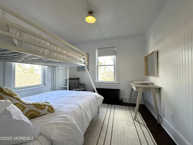 a spacious bedroom with a bed and a chandelier