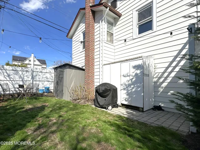 a view of a backyard with plants and a tub