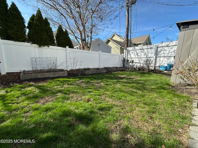 a view of a backyard with plants and a patio