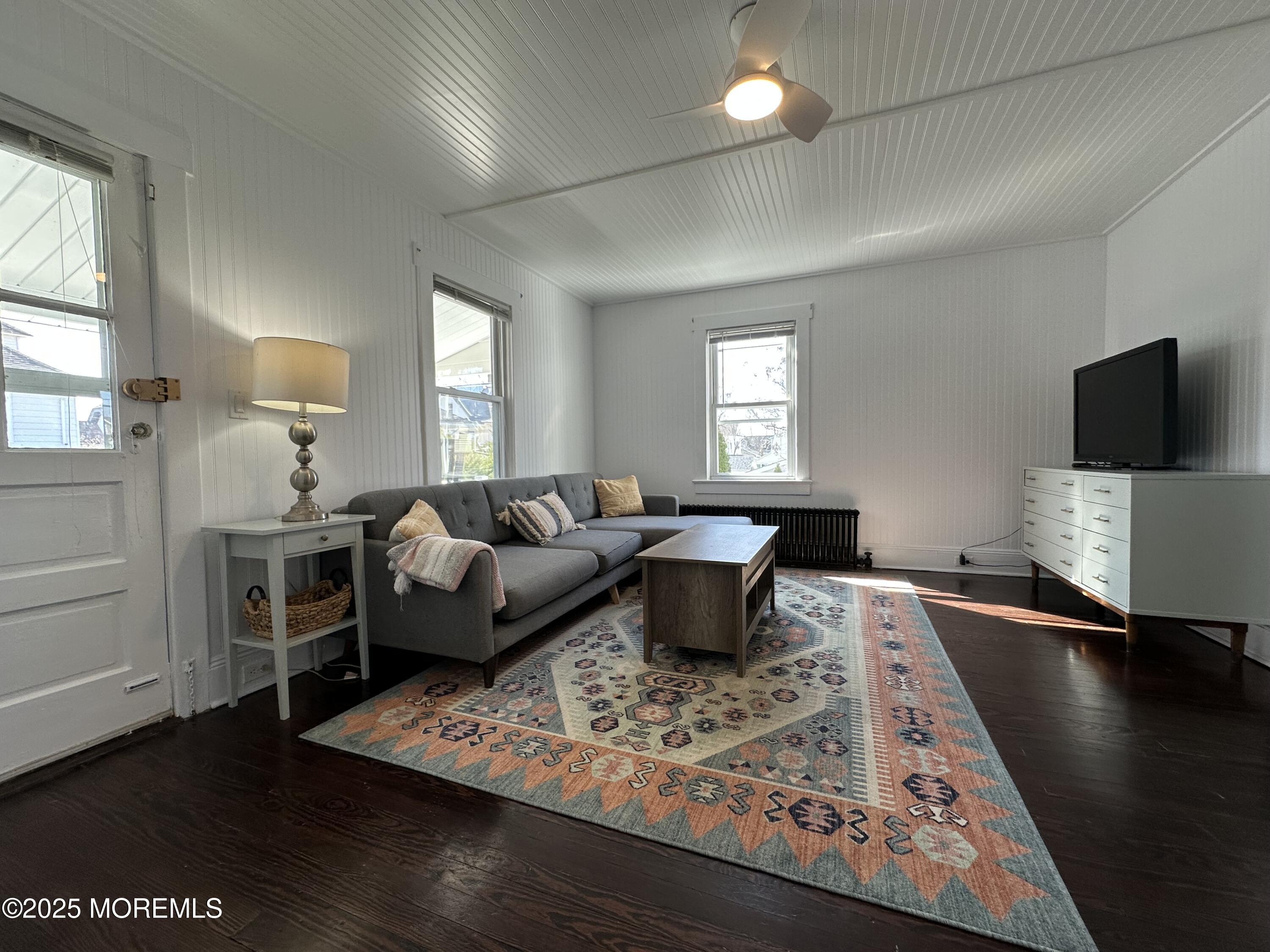 506 7th Avenue, Unit REAR Belmar, NJ 07719 - Photo 3 of 16 a living room with furniture a flat screen tv and a window
