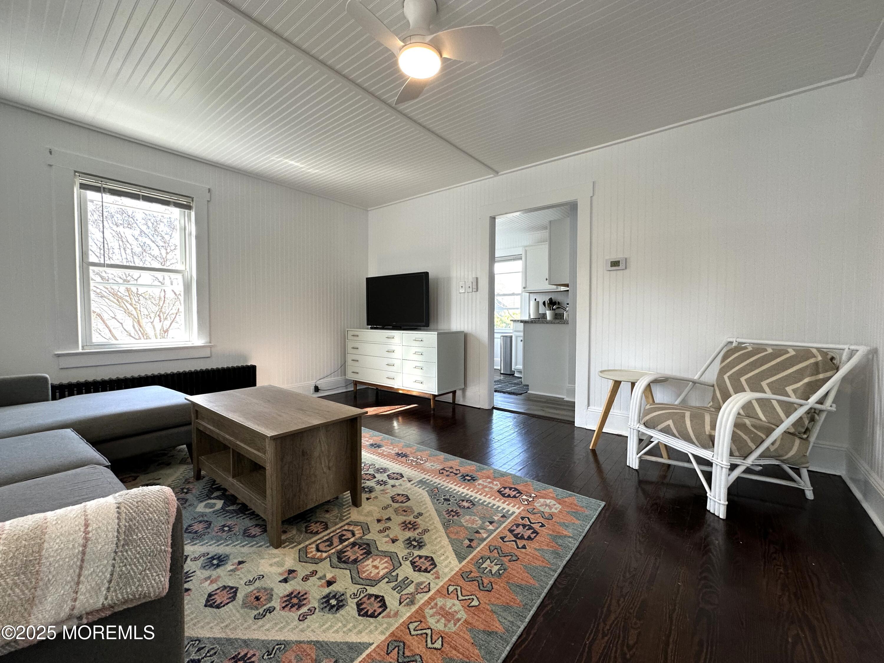 506 7th Avenue, Unit REAR Belmar, NJ 07719 - Photo 4 of 16 a living room with furniture and a flat screen tv