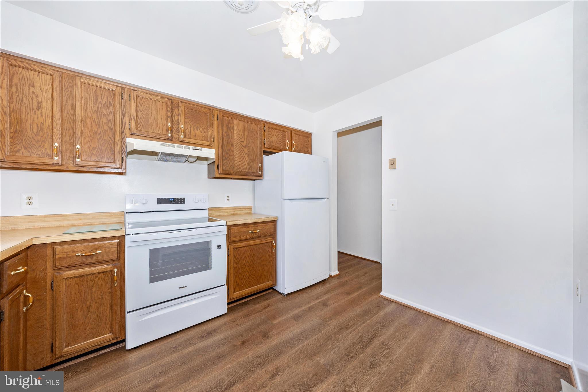 5738 Box Elder Court Frederick, MD 21703 - Photo 15 of 50 a kitchen with granite countertop white cabinets and white appliances