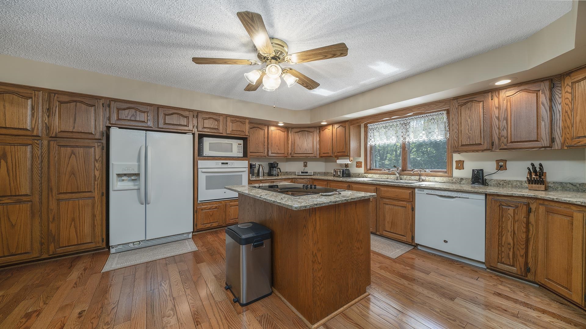 5221 West Edgewood Road Dixon, IL 61021 - Photo 8 of 43 a kitchen with granite countertop cabinets stainless steel appliances and a large window