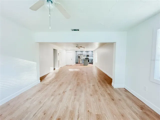 a view of a bedroom with wooden floor