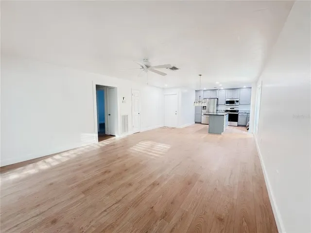 a view of a kitchen with a sink and a refrigerator