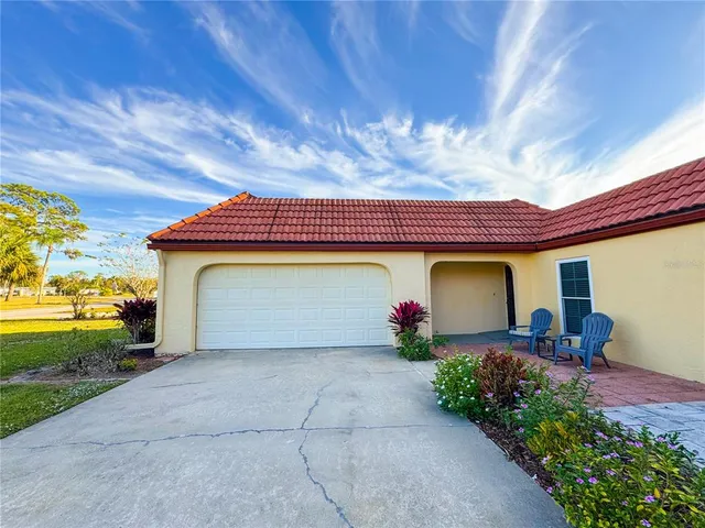 a view of a house with garage and entertaining space