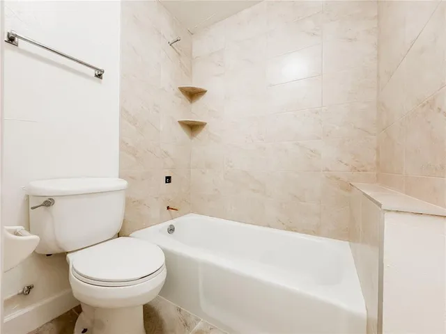 a bathroom with a toilet and a bathtub