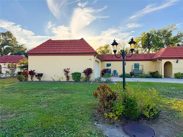 a view of a yard with a house and trees