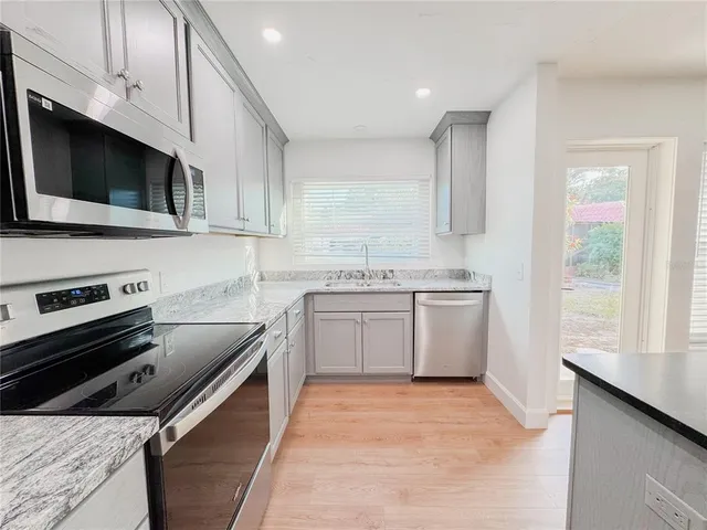 a kitchen with a sink stove and microwave