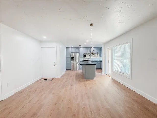 a view of kitchen with refrigerator sink and wooden floor