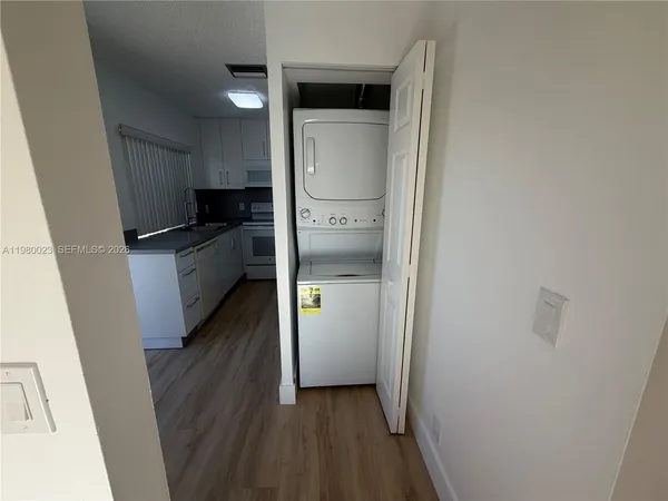 a kitchen with a refrigerator and a stove top oven