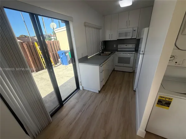 a kitchen with refrigerator a sink and a stove