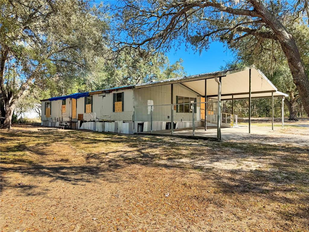 8191 Northeast 118 Terrace Bronson, FL 32621 - Photo 1 of 1 a backyard of a house with wooden fence