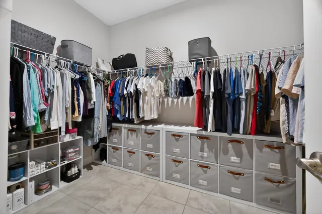 a view of walk in closet with clothes