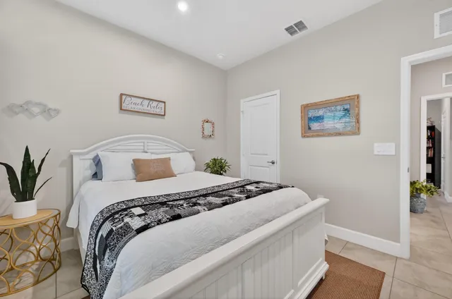 a bedroom with a bed and a painting on the wall