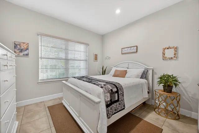 a bed room with a bed and a potted plant