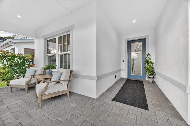 a view of a patio with furniture and garden