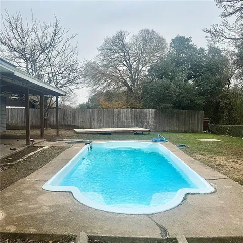 a view of a swimming pool with a patio