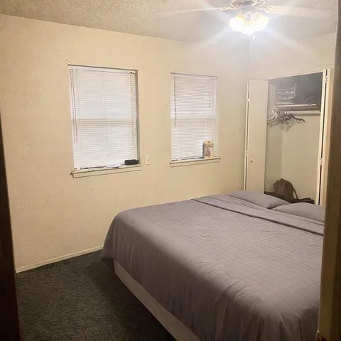 a bedroom with a bed and a window