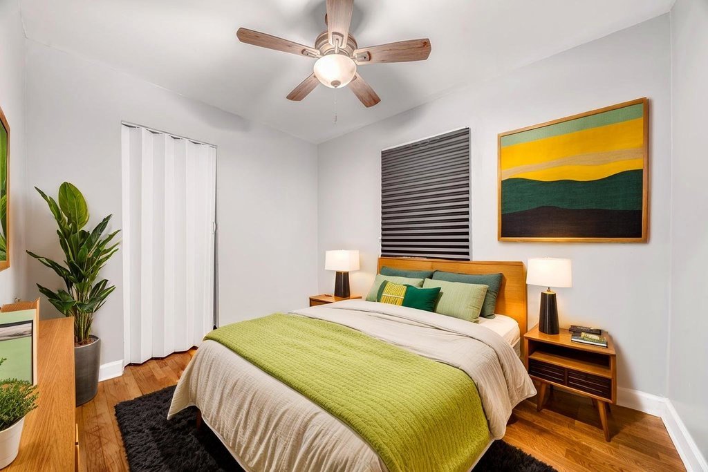 15417 Cherry Lane Markham, IL 60428 - Photo 13 of 24 a bedroom with a bed and a potted plant