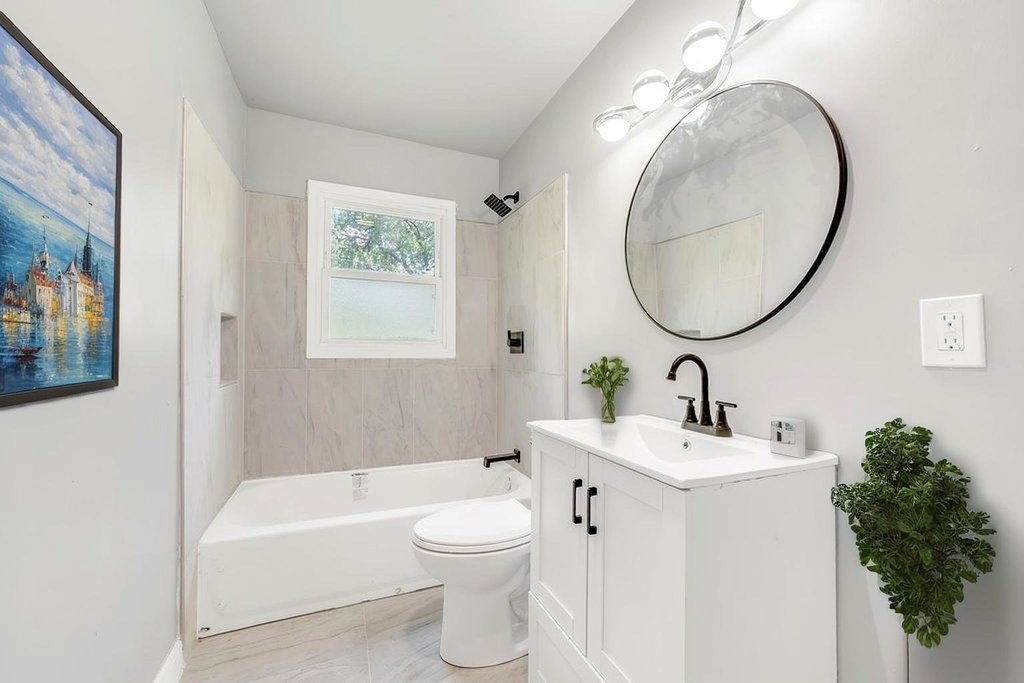 15417 Cherry Lane Markham, IL 60428 - Photo 14 of 24 a bathroom with a toilet a sink and a mirror