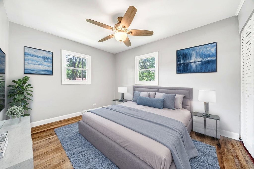 15417 Cherry Lane Markham, IL 60428 - Photo 10 of 24 a bedroom with a large bed and a chandelier