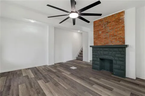 a view of empty room with fireplace and fan