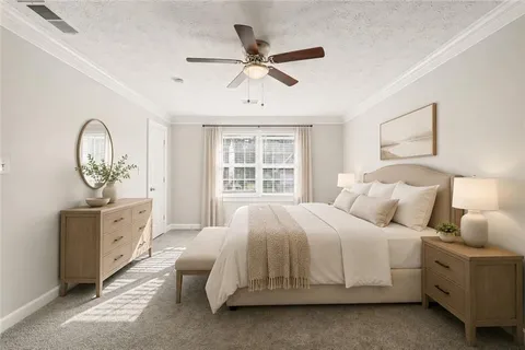 a bed sitting in a bedroom next to a window