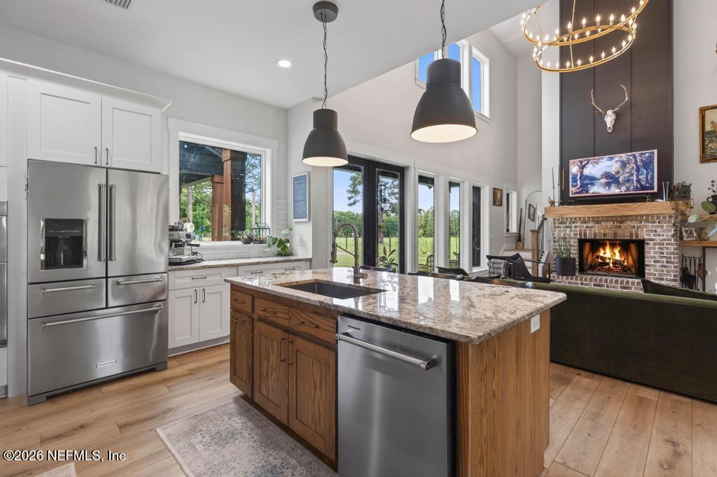 2955 Carroll Corner Road Hilliard, FL 32046 - Photo 36 of 106 a kitchen with stainless steel appliances granite countertop a stove and refrigerator