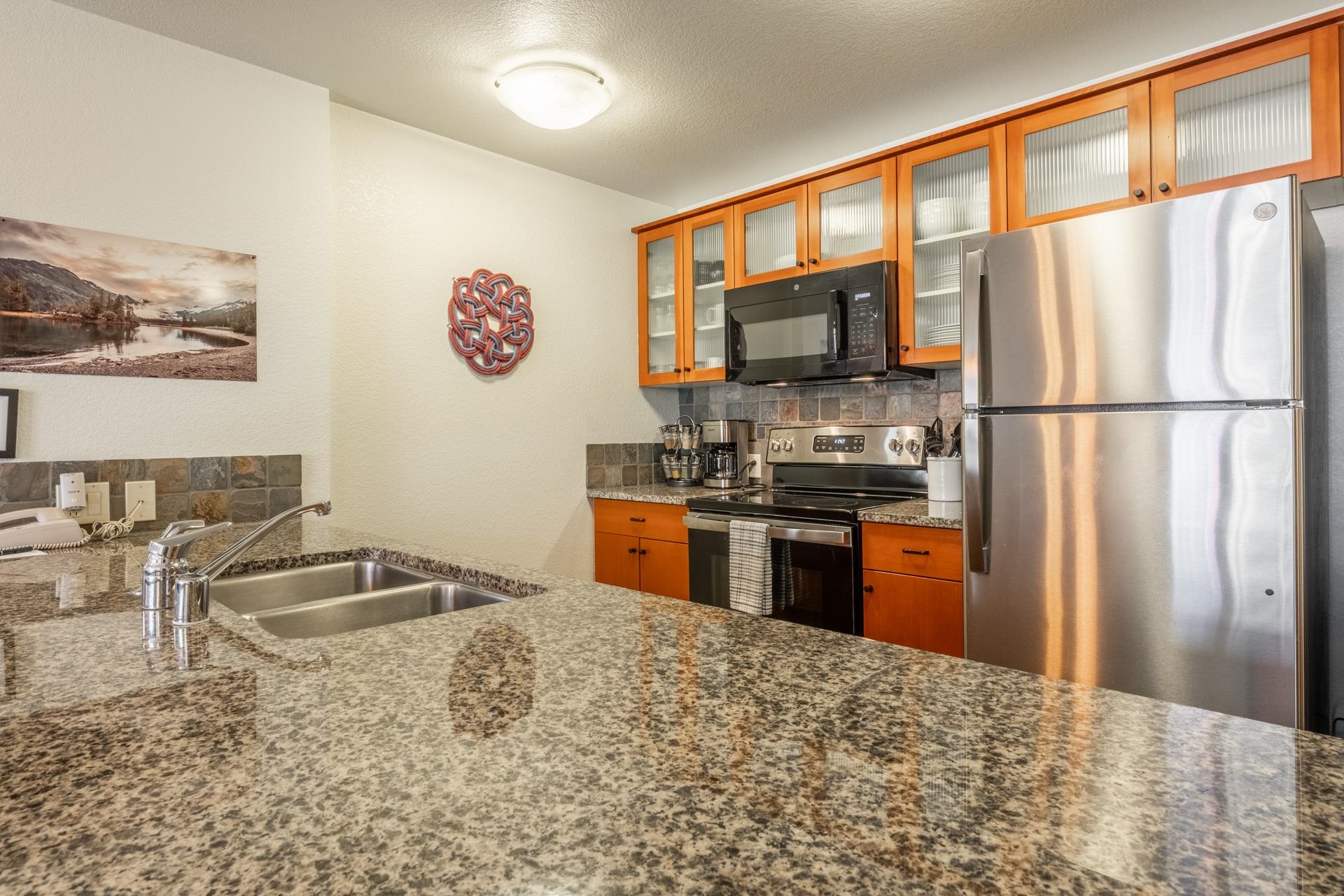 6201 Minaret Road, Unit 2312 Mammoth Lakes, CA 93546 - Photo 14 of 41 a kitchen with granite countertop a refrigerator and a stove top oven