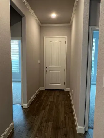 an empty room with wooden floor and closet