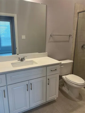 a bathroom with a sink a toilet and vanity