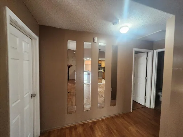 a view of a hallway with wooden floor