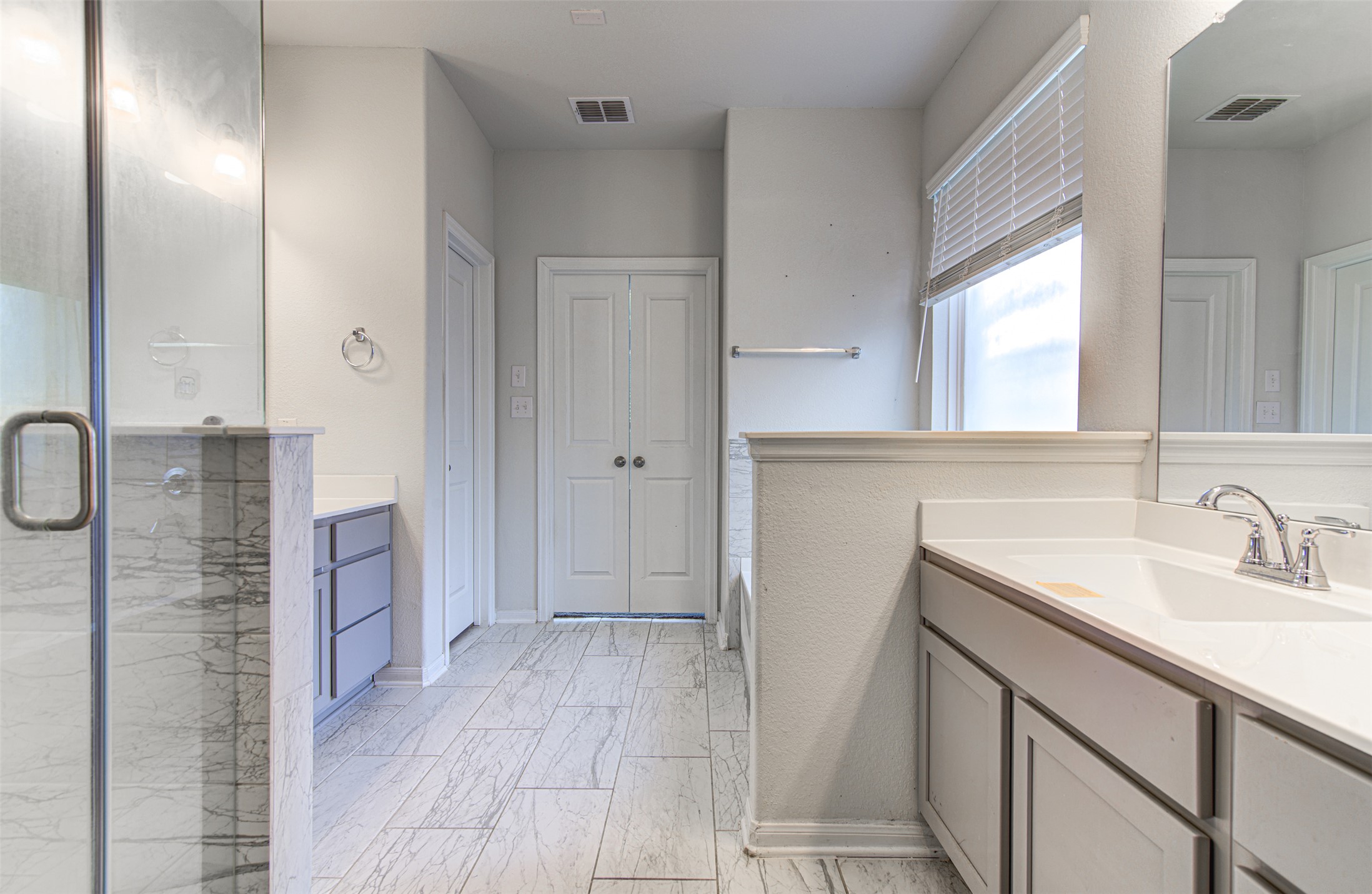 774 Cherrystone Loop Buda, TX 78610 - Photo 19 of 38 Marble-look tile flooring sets a clean, refined foundation in this well-appointed bathroom.