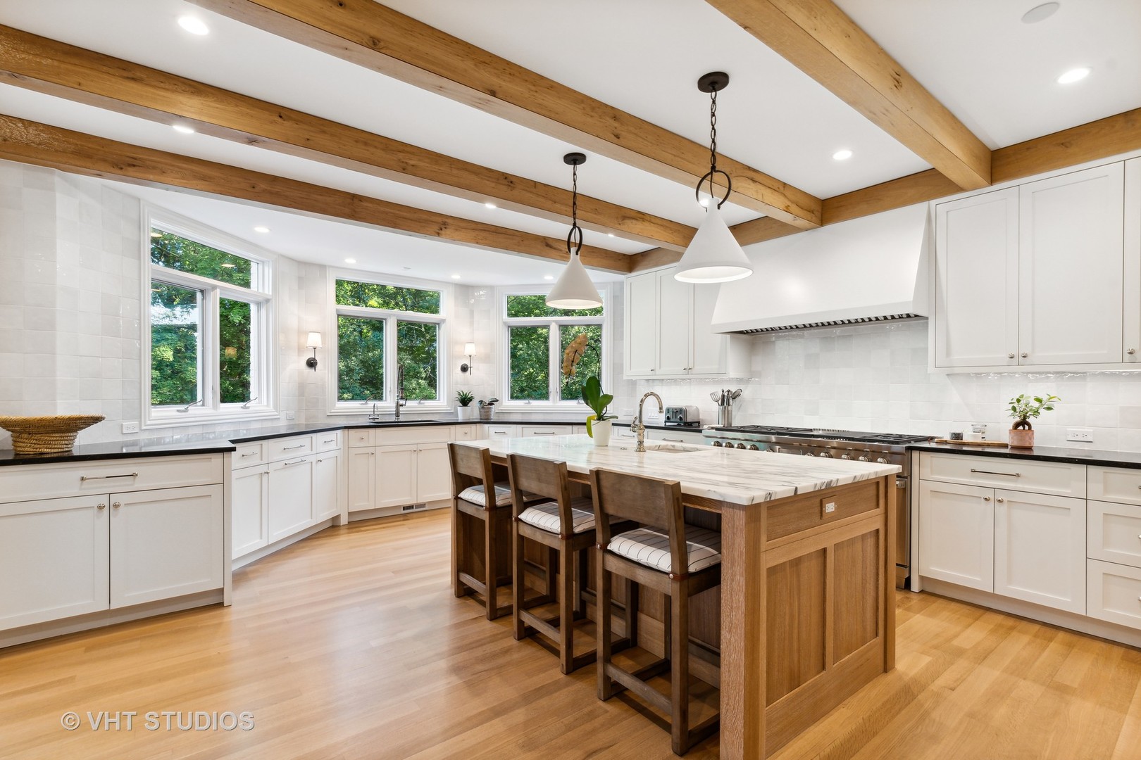 37 Sheridan Road Highland Park, IL 60035 - Photo 6 of 48 a kitchen with stainless steel appliances granite countertop a stove a sink dishwasher and a dining table with wooden floor