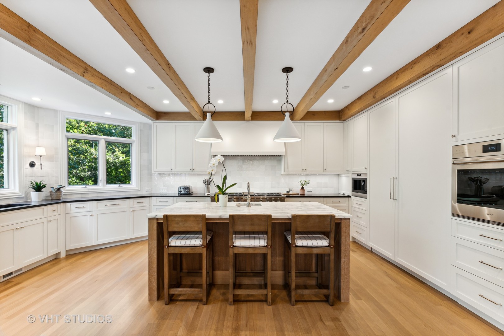 37 Sheridan Road Highland Park, IL 60035 - Photo 7 of 48 a kitchen with cabinets a sink and chairs in it