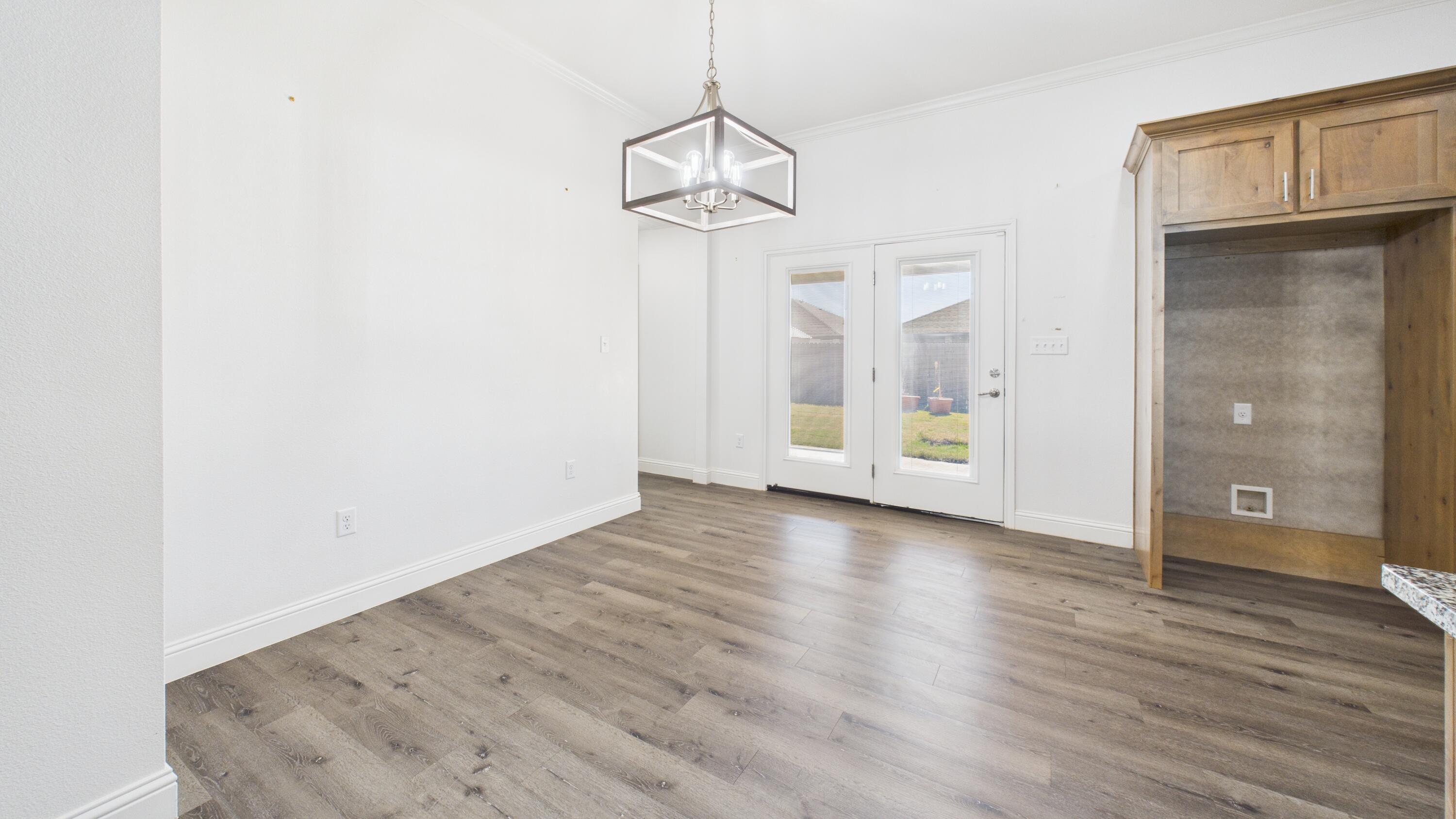 7107 23rd Street Lubbock, TX 79407 - Photo 15 of 49 a view of a room with wooden floor and windows